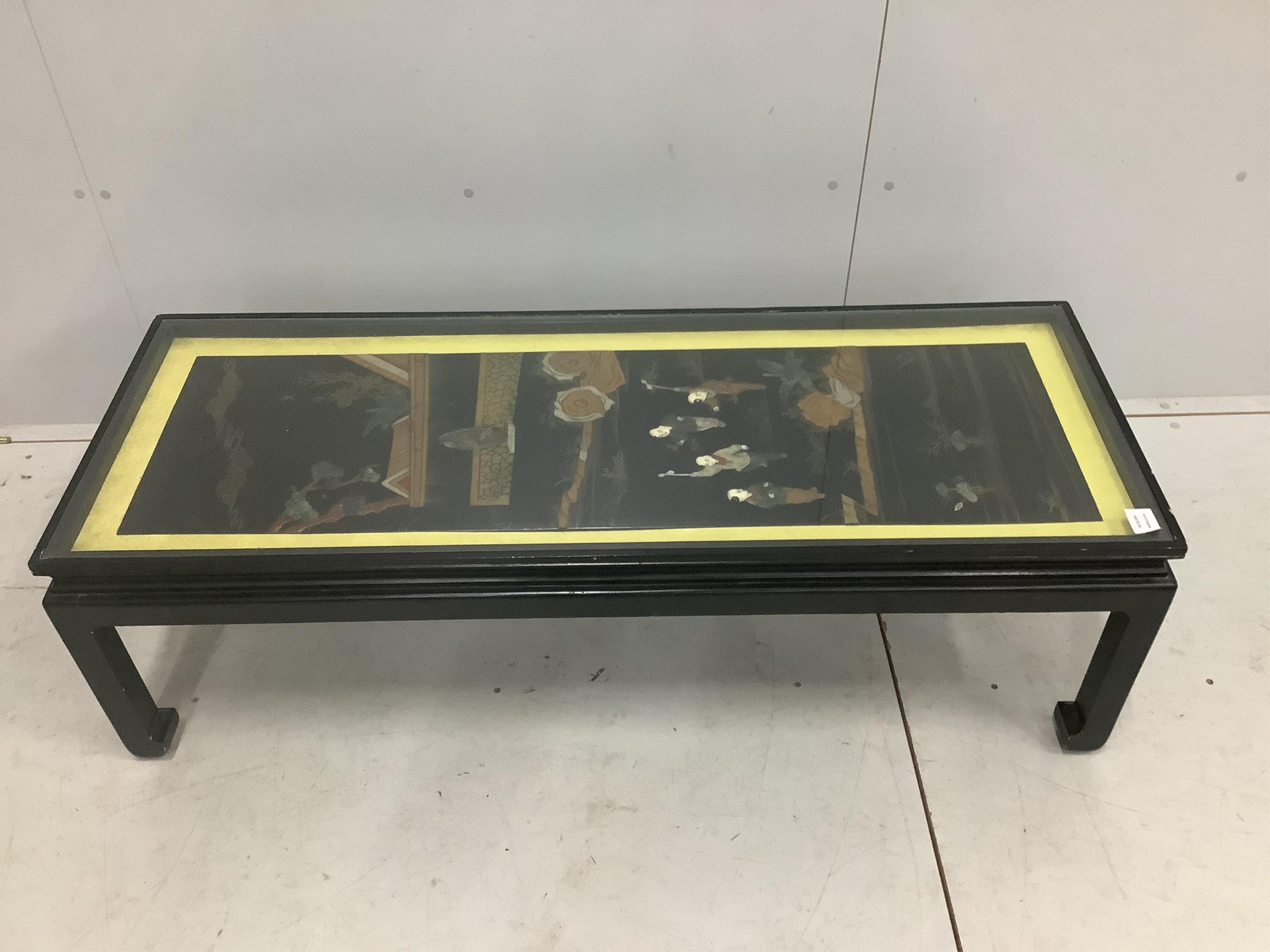 A Chinese ebonised table inset with a soapstone panel, width 132cm, depth 50cm, height 41cm. Condition - fair